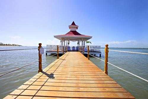 a wooden pier with a gazebo on the water at Bahia Principe Grand La Romana - All Inclusive in La Romana