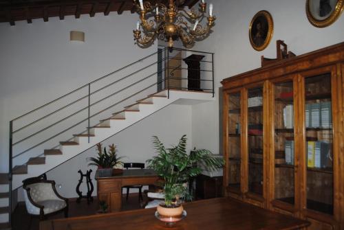 a living room with a staircase and a chandelier at Rovezzano B&B in Florence