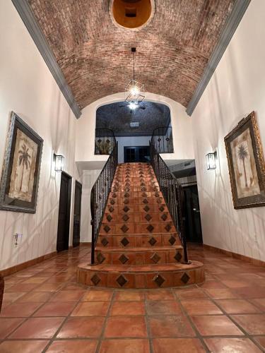 a hallway with a wooden staircase in a building at LUX 3 MASTER BDROOM ON SANDY BEACH w NO CLEAINING FEE in Puerto Peñasco