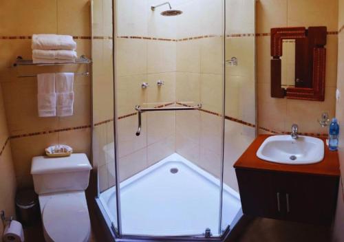 y baño con ducha, aseo y lavamanos. en Casa Lloret, en Cuenca
