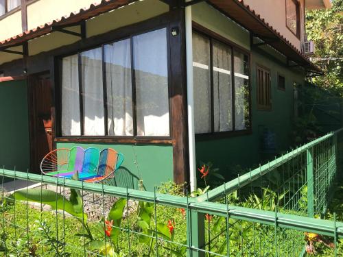 a house with two chairs on the front porch at FLOR DE PARAISO BUNGALOWS in Montezuma