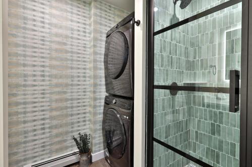 a washing machine in a bathroom with a window at NEW Killington Studio with Kitchenette, WiFi, TV, Fireplace, Close to Resort on the Shuttle Route, 213 condo in Killington
