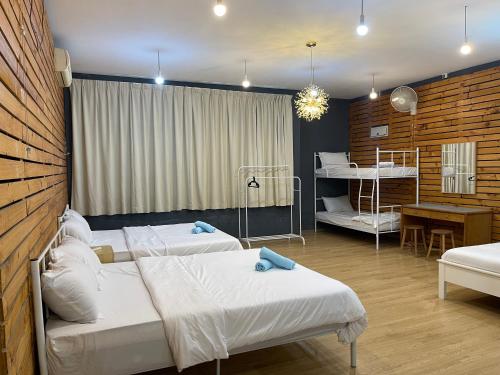 two beds in a room with two bunk beds at Stylishly Spacious in Tanjung Bungah