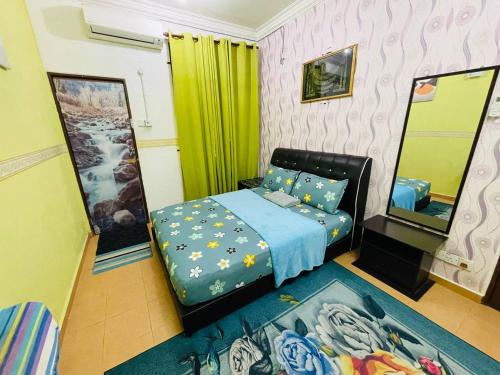 a bedroom with a bed and two mirrors at Niks Homestay Kok Lanas in Kampong Kok Lanas