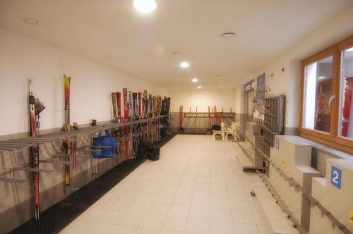a room with many racks of skis on the wall at Camping Catinaccio Rosengarten in Pozza di Fassa