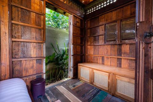 a sauna with a bench in a wooden room at Kubu Kirana by Supala in Ubud
