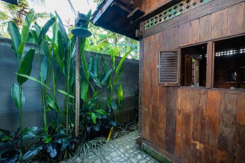 a wooden building with plants in front of it at Kubu Kirana by Supala in Ubud