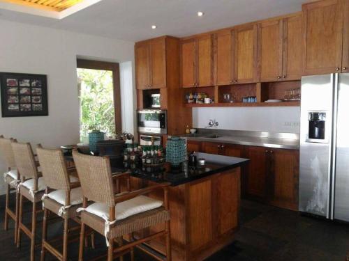 a kitchen with a table and a white refrigerator at Villa Presito in Ronda