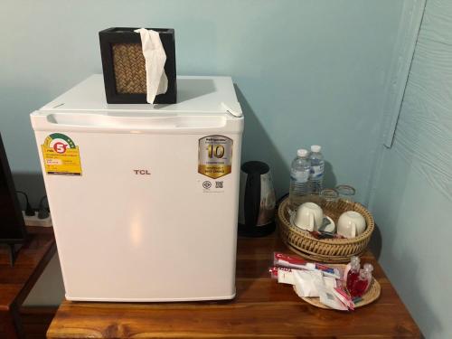 a white refrigerator with a box on top of it at เชียงคานพาราไดร์รีสอร์ท&มีตติ้ง in Ban Na Bon (1)