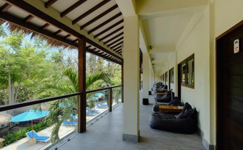 an open lobby with a view of a resort at Trawangan Nirvana in Gili Trawangan