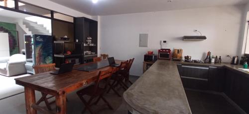 a kitchen with a wooden counter top in a room at Bravo Hostels: Surf House in Punta Hermosa