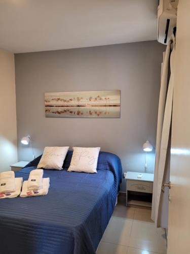 1 dormitorio con 2 camas y un cuadro en la pared en Departamento excelente ubicación en San Juan