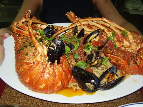 a plate of food with seafood on a table at Hotel Penelope in Boukari