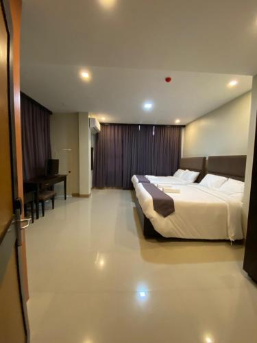 a hotel room with two beds and a desk at Eight Breeze in Baclayon