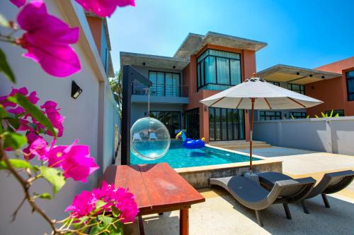a backyard with a swimming pool and a house at Aonang nine poolvilla in Ao Nang Beach