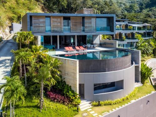an aerial view of a house with a swimming pool at The Cube Ocean View Pool Villa Kalim in Patong Beach