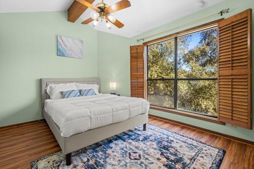 a bedroom with a bed and a large window at Villa Española in San Antonio