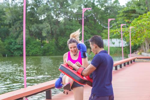 a man holding a woman on an inflatable at Cassia Phuket, part of Banyan Group in Bang Tao Beach