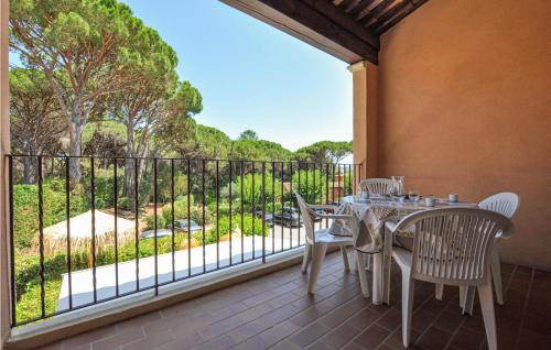 a patio with a table and chairs on a balcony at Awesome Apartment In Sainte-Maxime in Sainte-Maxime
