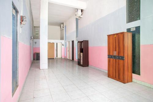 a hallway of a hospital with a wooden locker at Hotel O Ibma Smart Syariah in Pasuruan