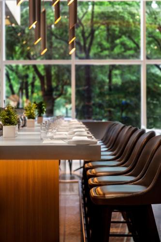 a row of benches in a room with a window at Trump International New York in New York