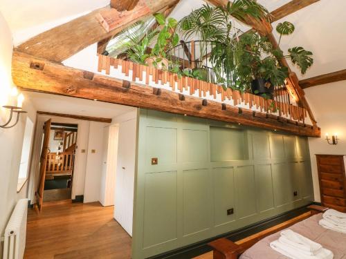 a large green garage with plants on the ceiling at Tickmorend Farm in Stroud