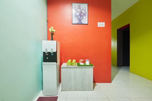 a colorful room with a refrigerator and a counter at SY JERANTUT HOTEL in Jerantut