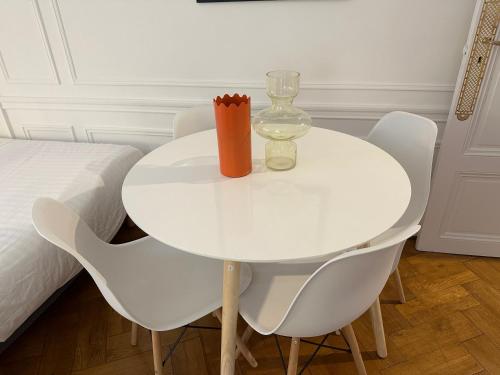 a white dining room table with chairs and a glass at Luxurious Apartment with AC Promenade des Anglais up to 4 people B in Nice