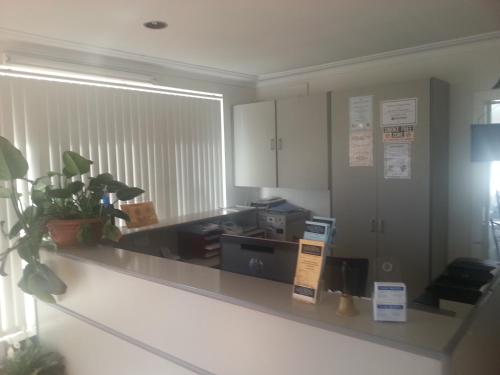 a kitchen with a counter with a microwave at Yass Motel in Yass