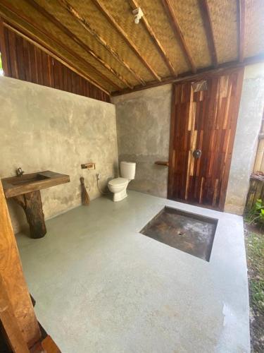 a bathroom with a toilet and a sink at Sarini Villas in Blahbatu