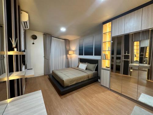 a bedroom with a bed and a large window at Deluxe Residence Kalibata 8 in Jakarta