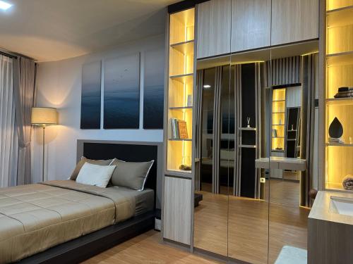 a bedroom with a bed and a bathroom with a sink at Deluxe Residence Kalibata 8 in Jakarta