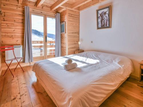 a bedroom with a bed with a teddy bear on it at Chalet Le Grand-Bornand, 6 pièces, 12 personnes - FR-1-391-116 in Le Grand-Bornand