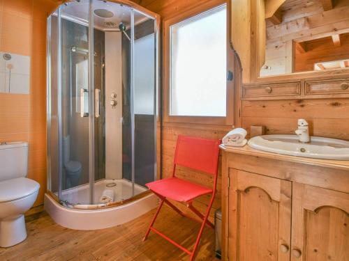 a bathroom with a shower and a red chair in it at Chalet Le Grand-Bornand, 6 pièces, 12 personnes - FR-1-391-116 in Le Grand-Bornand
