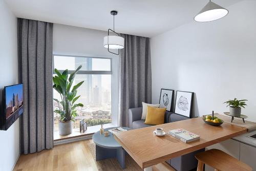 a living room with a table and a couch at base-SUHE Serviced Apartment in Shanghai