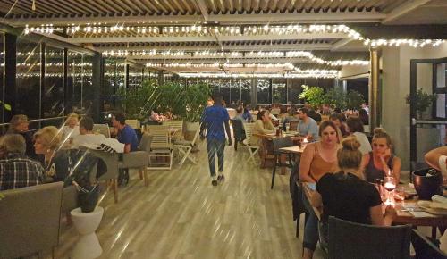 a group of people sitting in a restaurant at Brenton Haven Beachfront Resort in Knysna