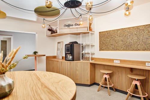 a coffee shop with a table and two stools at HOMEBOUND APARTMENTS Bad Goisern - contactless check-in in Bad Goisern