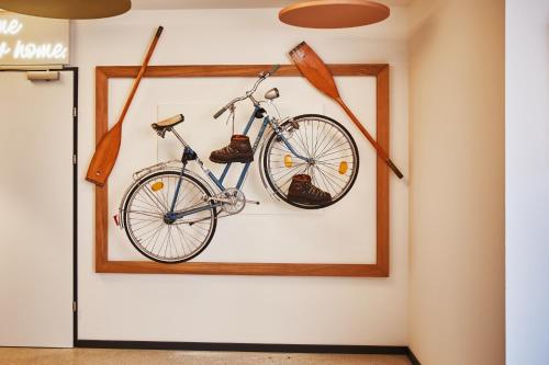 a bike and boots hanging on a wall at HOMEBOUND APARTMENTS Bad Goisern - contactless check-in in Bad Goisern
