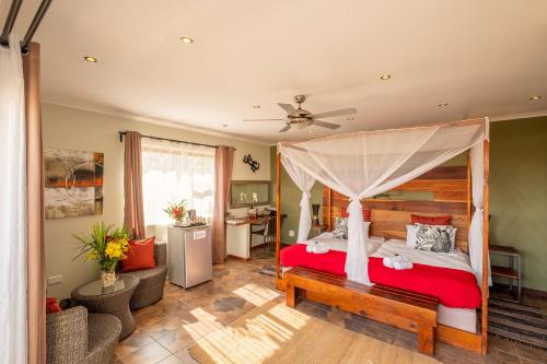 a bedroom with a bed with a canopy at Gecko Ridge in Swakopmund