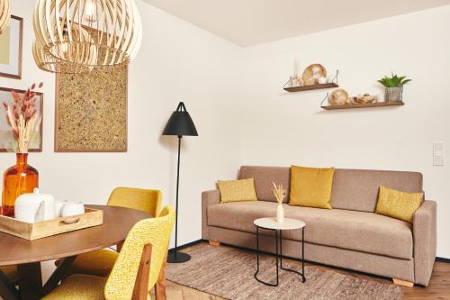a living room with a couch and a table at HOMEBOUND APARTMENTS Bad Goisern - contactless check-in in Bad Goisern