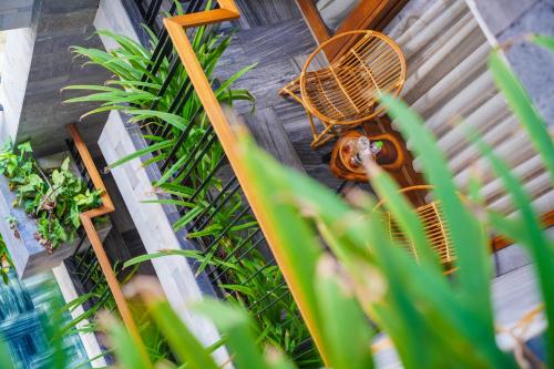 an overhead view of a table and bench and plants at Bonny Boutique Hotel Da Nang in Da Nang