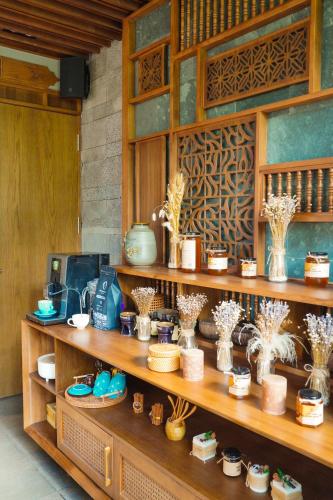 a shelf with vases and other items on it at Bonny Boutique Hotel Da Nang in Da Nang