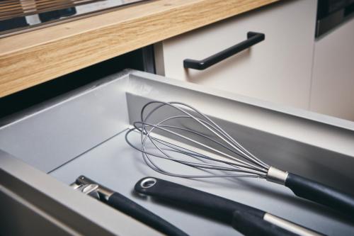 a whisk sitting in a drawer in a kitchen at HOMEBOUND APARTMENTS Bad Goisern - contactless check-in in Bad Goisern