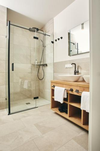 a bathroom with a shower and a sink at HOMEBOUND APARTMENTS Bad Goisern - contactless check-in in Bad Goisern