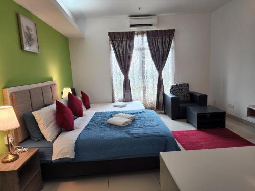 a bedroom with a bed and a chair and a window at The Viana Apartment 2 in Kota Bharu