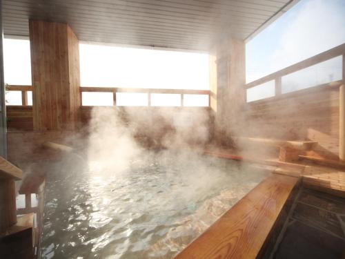 a bath room with a pool of water at Kawayu Kanko Hotel in Teshikaga