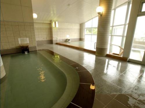 a large room with a pool in the middle of a building at Kawayu Kanko Hotel in Teshikaga