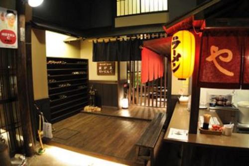 a restaurant with a wooden floor and a room with a table at Kawayu Kanko Hotel in Teshikaga