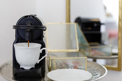 a coffee maker sitting on a table with a cup at Residenza di Fedralia in Nafplio