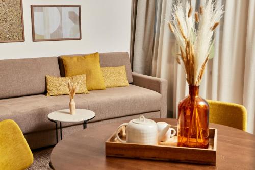 a living room with a couch and a table at HOMEBOUND APARTMENTS Bad Goisern - contactless check-in in Bad Goisern